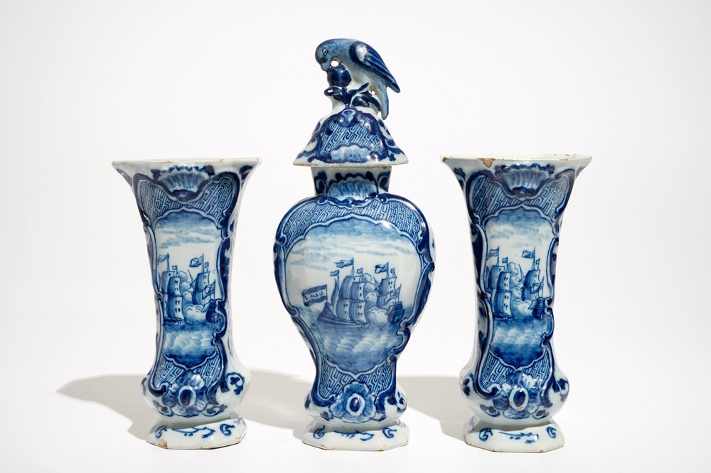 A Dutch Delft blue and white three-piece garniture with a naval scene, 18th C.