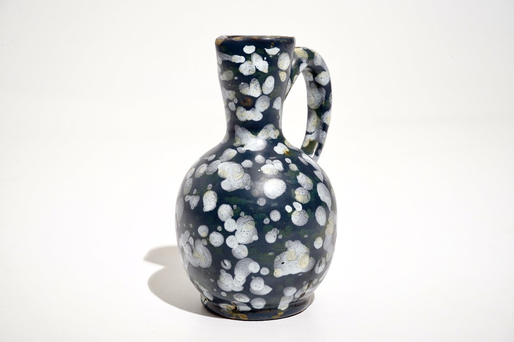 A French faience jug with blue ground "A la bougie" design, Nevers, 17th C.