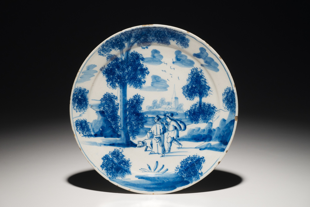 A Dutch Delft blue and white plate with figures in a landscape, 1st half 18th C.