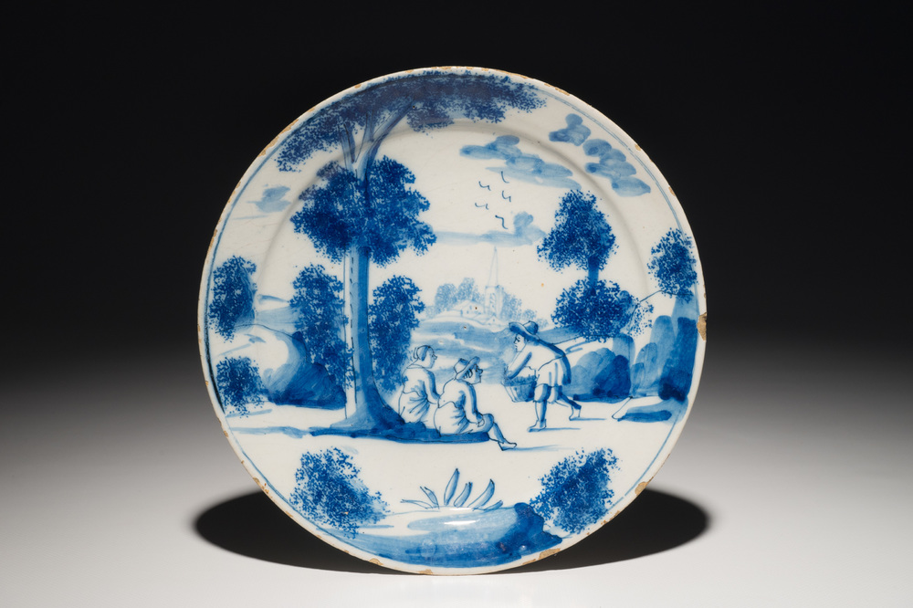 A Dutch Delft blue and white plate with figures in a landscape, 1st half 18th C.