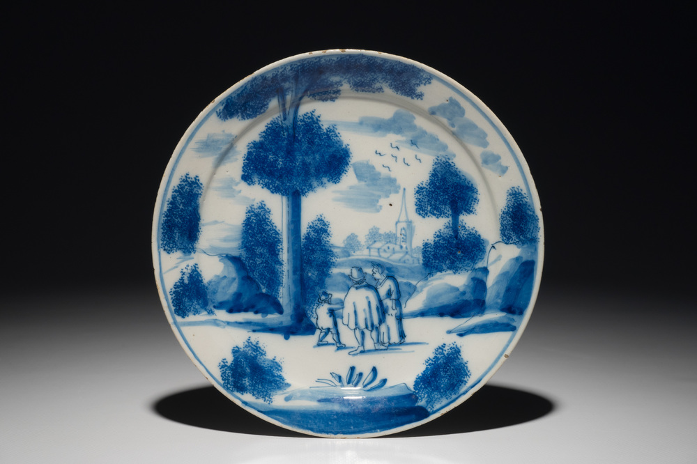 A Dutch Delft blue and white plate with figures in a landscape, 1st half 18th C.