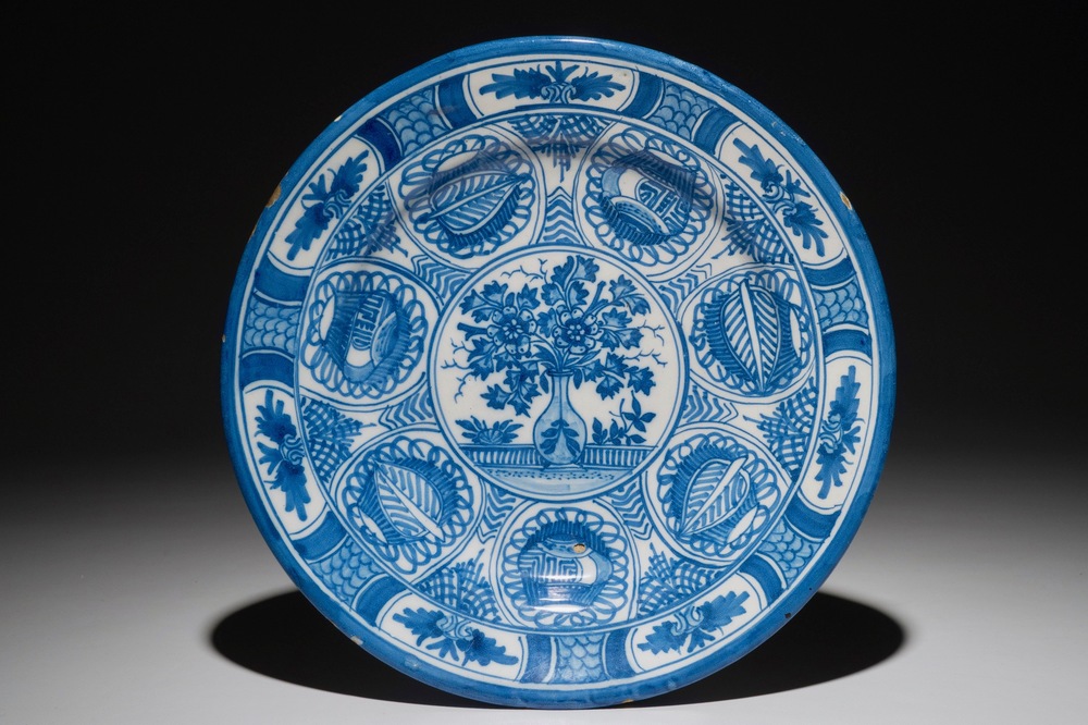 A Dutch Delft blue and white chinoiserie dish with a flower vase in Wanli style, 2nd half 17th C.