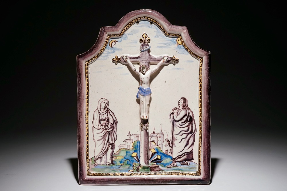 A polychrome Dutch Delft relief-decorated "Crucifixion" plaque, Utrecht, 1st half 19th C.