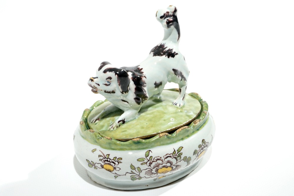 A polychrome Dutch Delft butter tub with a dog, 18th C.