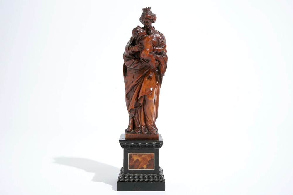 A carved boxwood Madonna with child on tortoise veneer base, 17th C.
