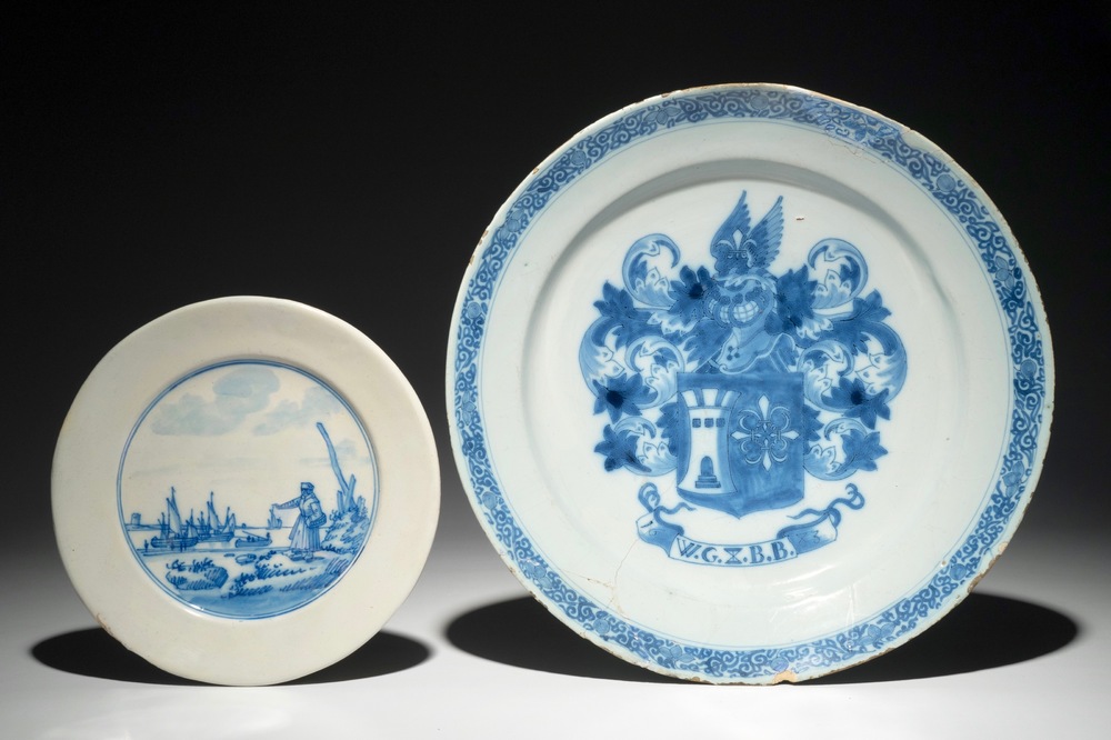 A Dutch Delft blue and white armorial dish dated 1683 and a blue and white landscape plate, 17th C.