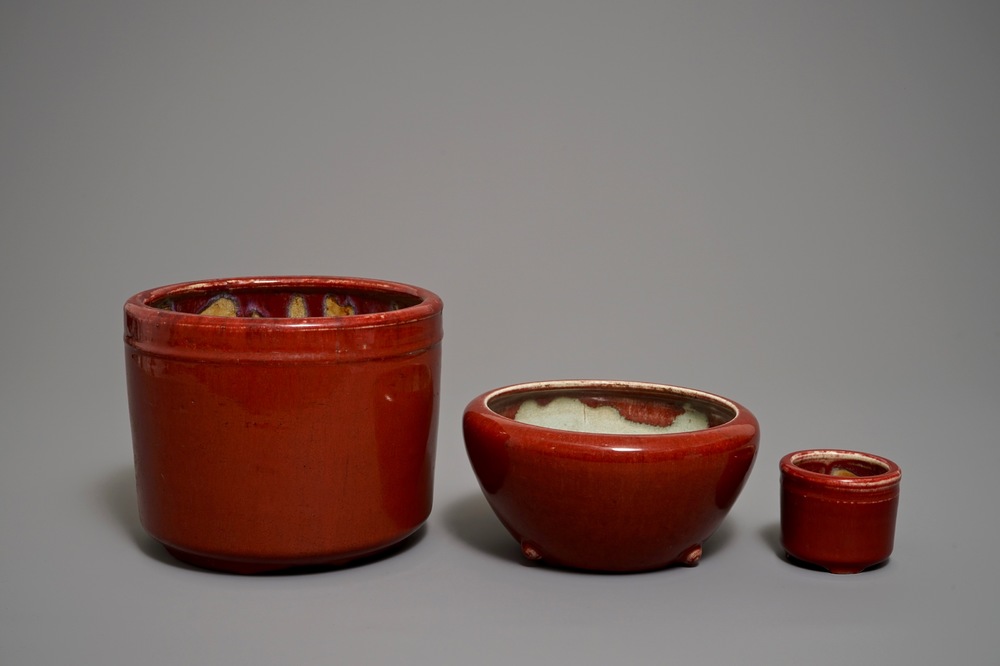 Two Chinese oxblood-glazed brush pots and an incense burner, 19/20th C.
