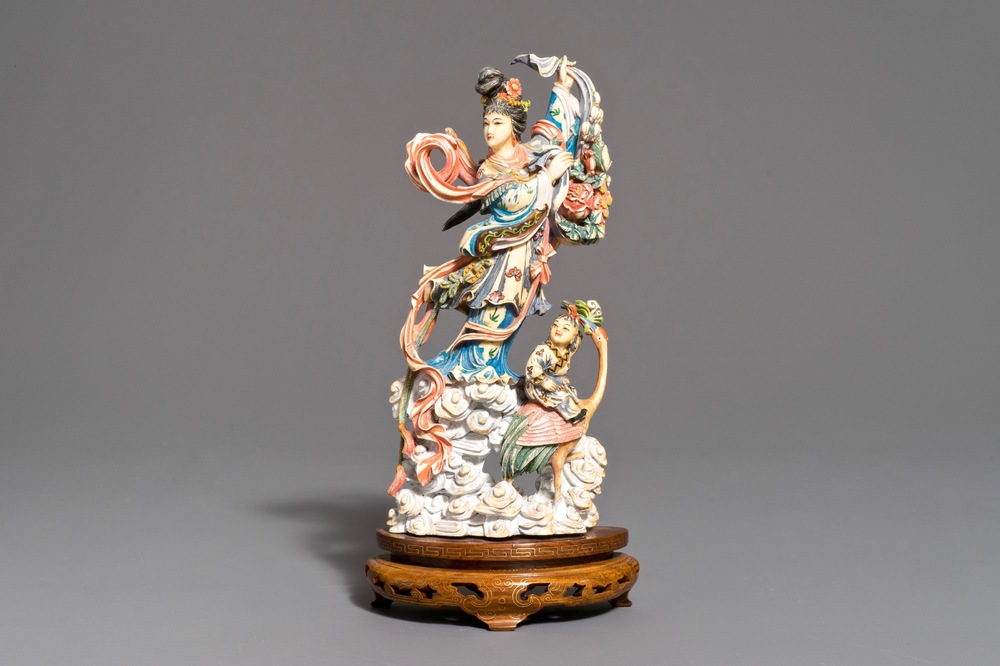 A Chinese polychrome carved ivory figure of Magu on wooden base, 1st half 20th C.
