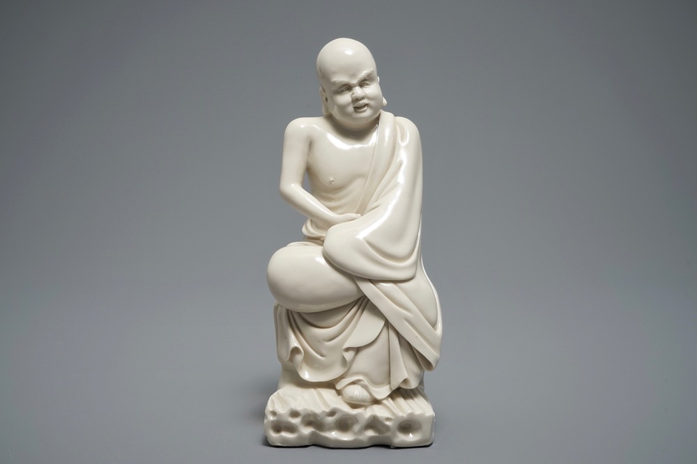 A Chinese Dehua blanc de Chine figure of a Luohan, 19th C.