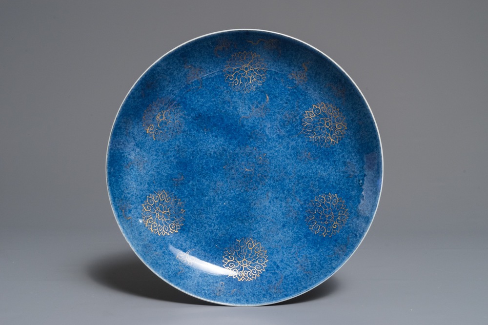 A Chinese powder blue and gilt lotus scroll dish, Kangxi