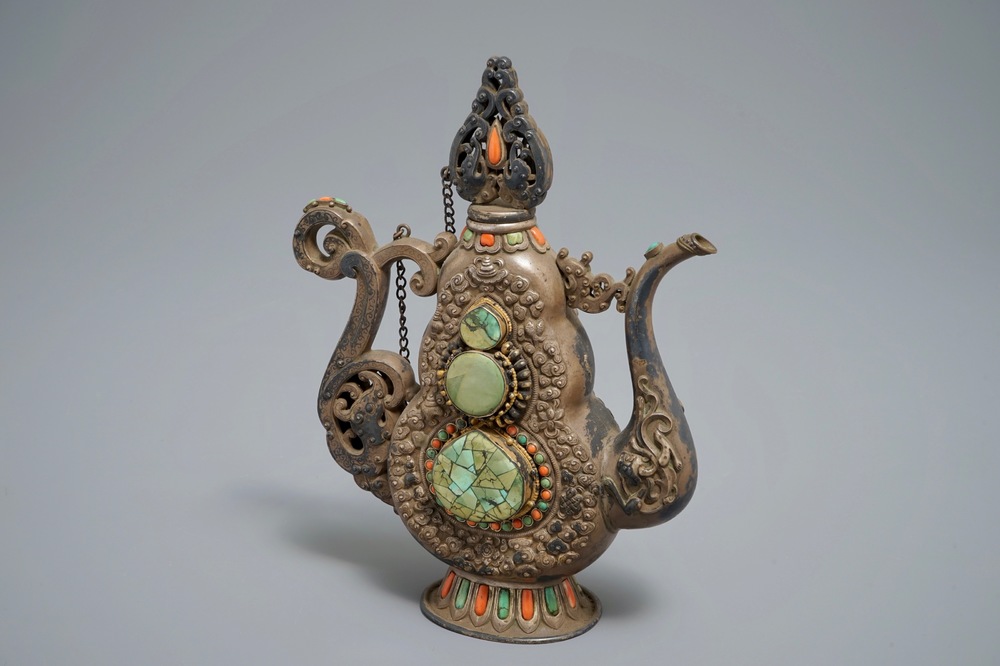 A silvered and parcel-gilt brass jug inlaid with turquoise and coral, Tibet or Mongolia, 19th C.