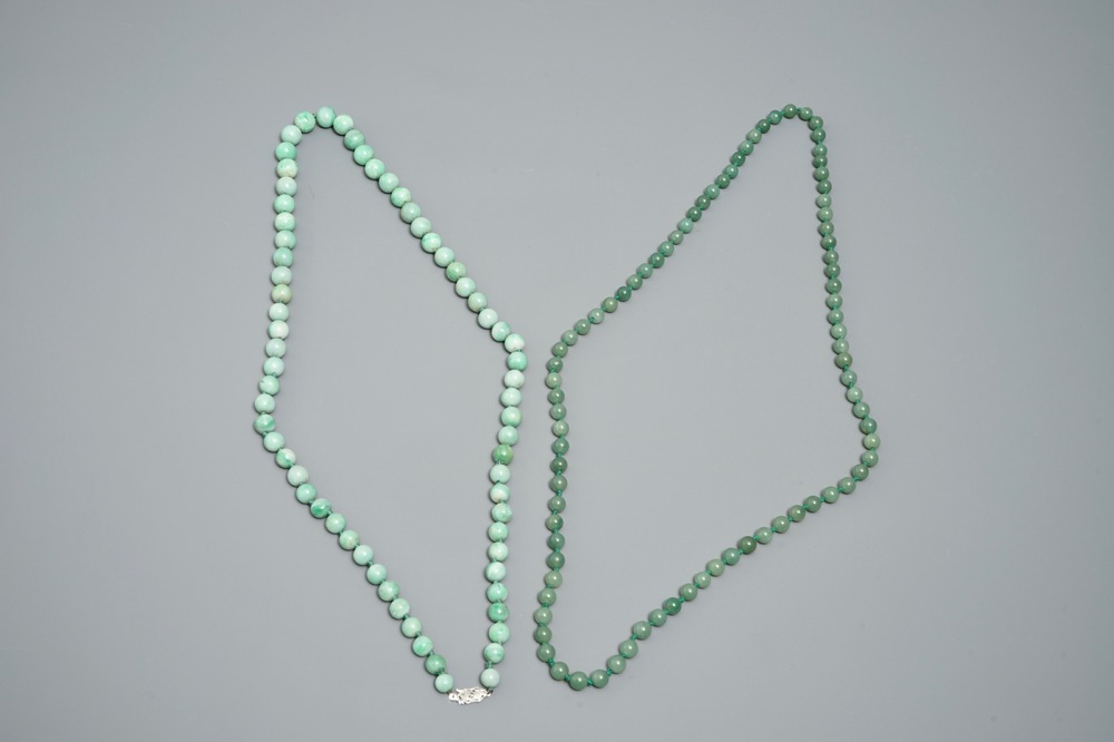 Two Chinese green jade beads necklaces, one with silver lock, 19/20th C.