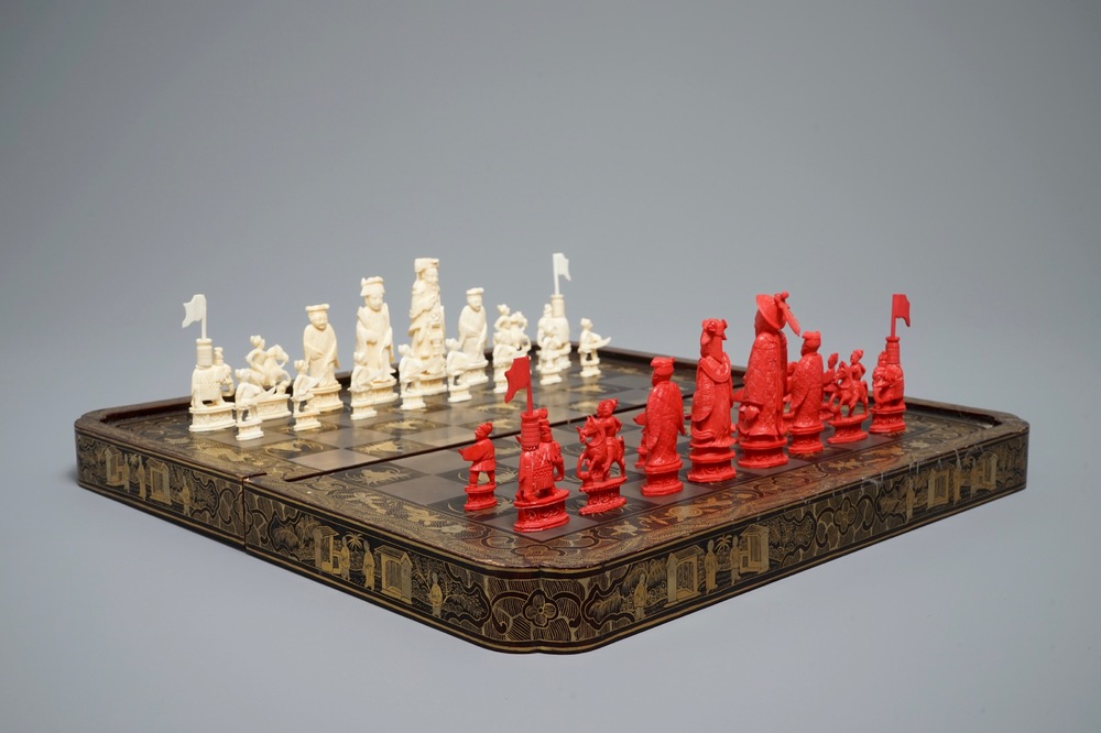A Chinese lacquered chess and backgammon board with ivory chessmen, 19th C.