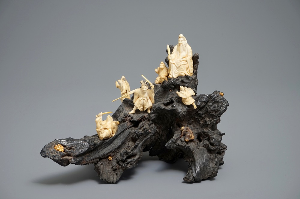 A Japanese carved ivory group on rootwood base, prob. Tokyo school, Meiji, 19th C.