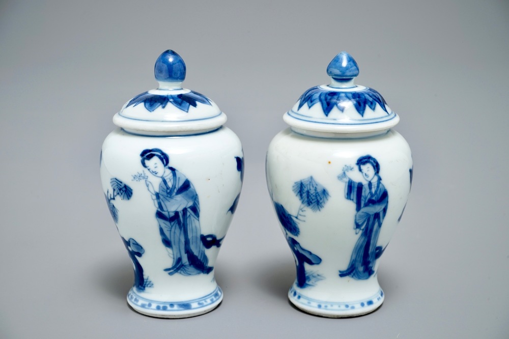 A pair of Chinese blue and white miniature vases and covers or tea caddies, Kangxi