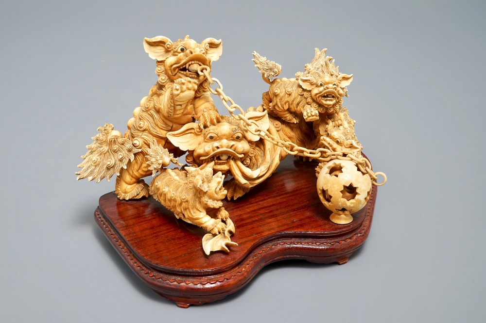 A Chinese carved ivory group of Buddhist lions playing with a ball, 19/20th C.