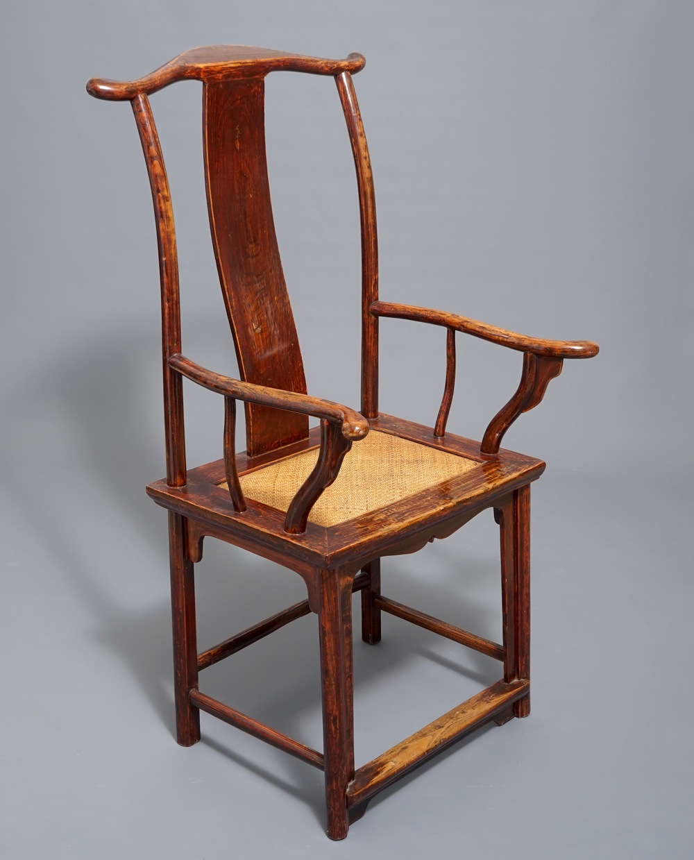 A Chinese elm wood "official's hat" armchair, 19th C.