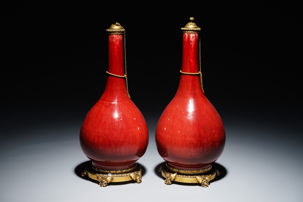 A pair of Chinese gilt bronze-mounted oxblood-glazed vases, 19th C.