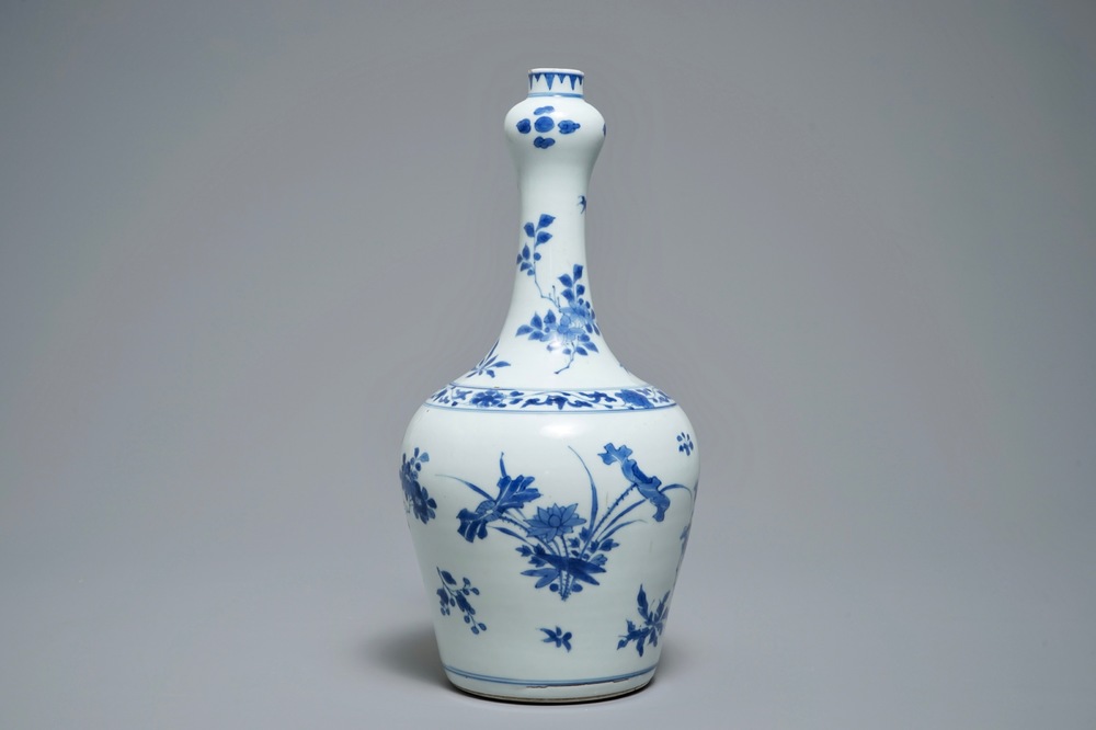 A Chinese blue and white bottle vase with floral design, Transitional period