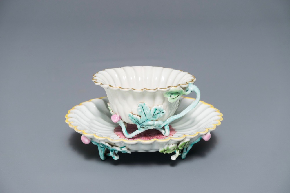 A Chinese famille rose lotus-shaped relief-decorated cup and saucer, Yongzheng