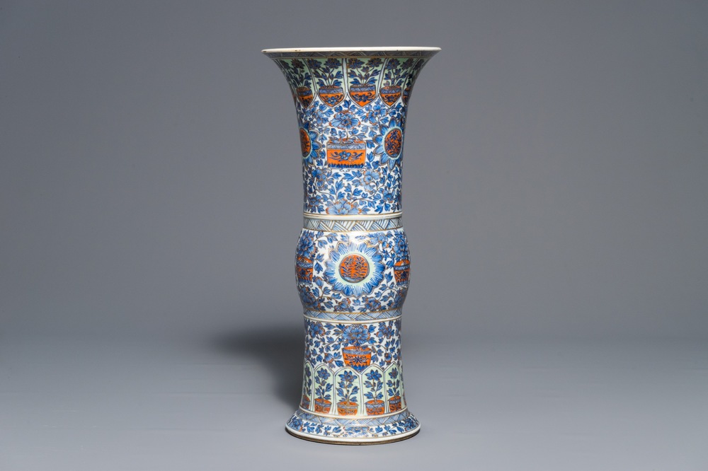 A clobbered Chinese blue and white 'gu' beaker vase, Kangxi