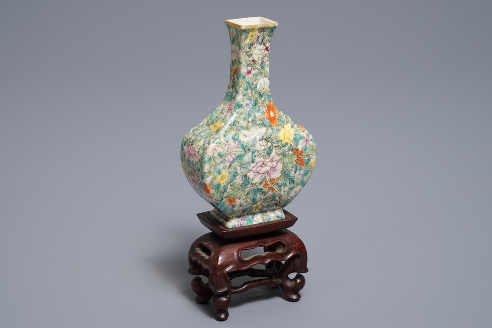 A Chinese eggshell famille rose millefleurs vase on stand, Qianlong mark, 18/19th C.