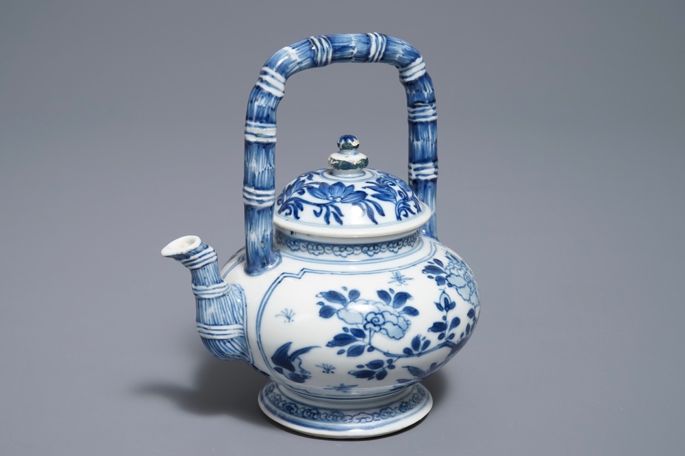 A Chinese blue and white gate-handled teapot and cover, Kangxi