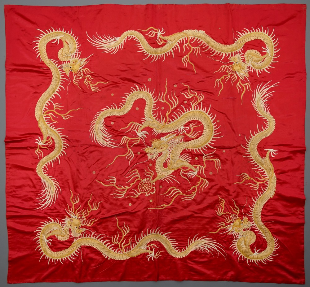 A Vietnamese embroidered red ground silk panel with dragons, 19th C.