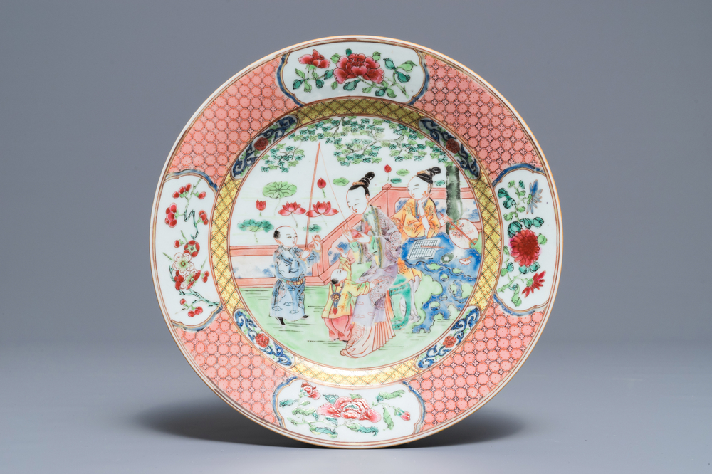 A Chinese famille rose plate with figures in a garden, Yongzheng