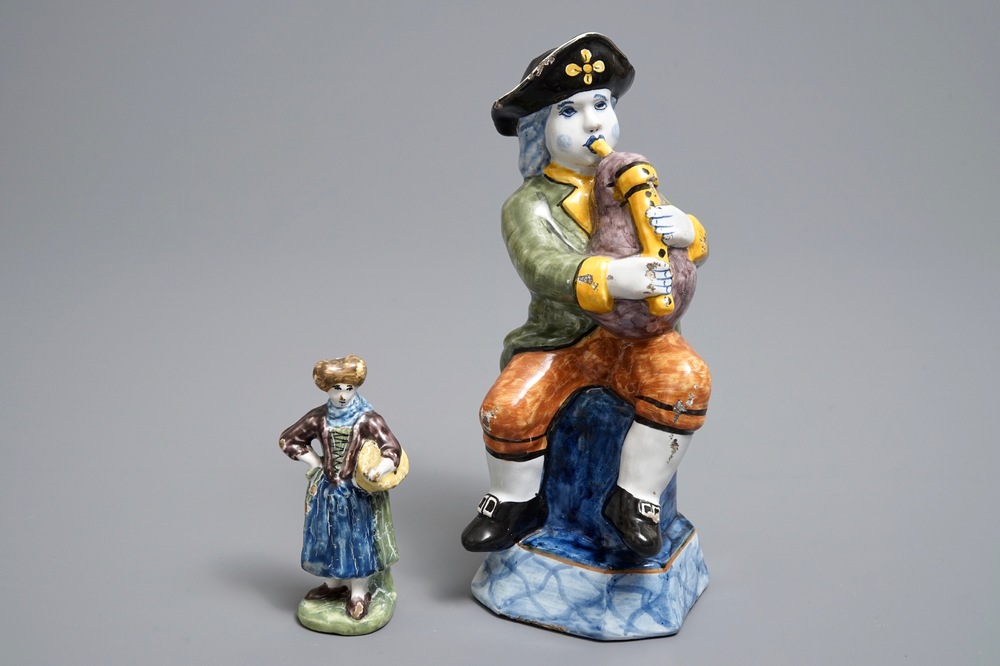 Two polychrome Dutch Delft models of a bagpipe player and a lady, 19th C.