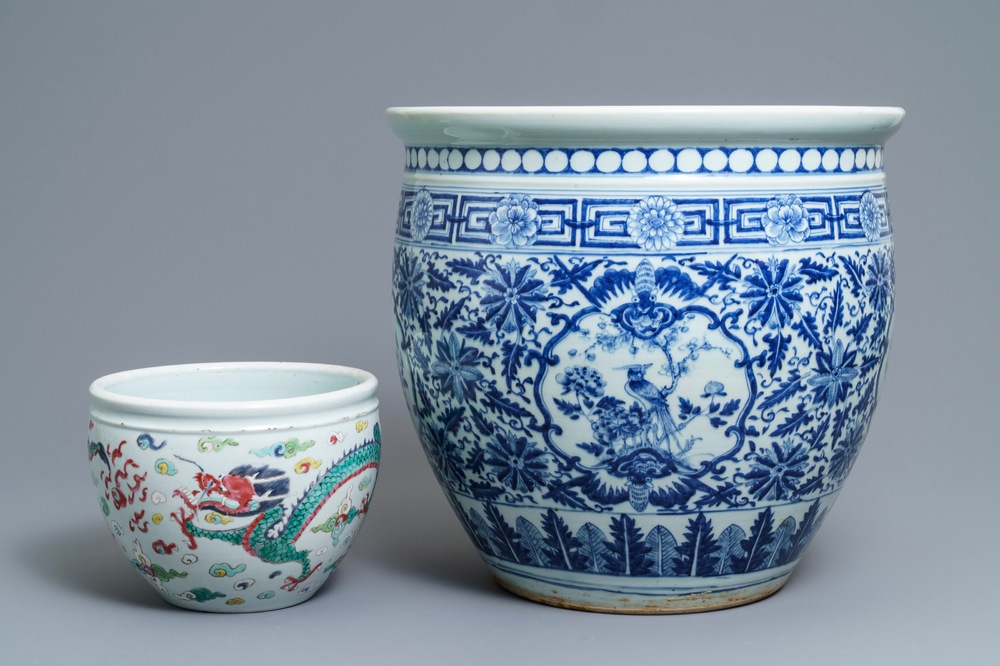 A Chinese blue and white fish bowl and a famille rose 'dragon' jardini&egrave;re, 19th C. and Yongzheng