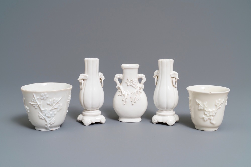 Three Chinese blanc de Chine vases and two cups with applied designs, Kangxi and later