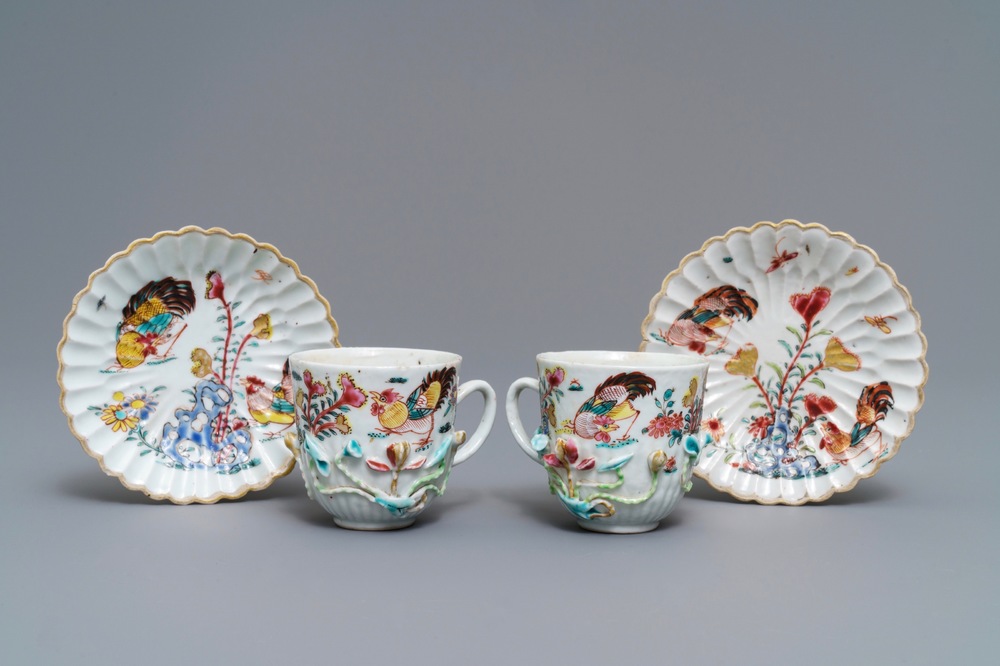 A pair of Chinese famille rose 'rooster' cups and saucers with applied floral designs, Yongzheng
