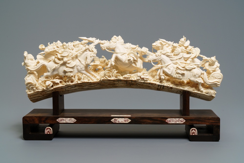 A Chinese carved ivory group with warriors on horseback, 2nd quarter 20th C.