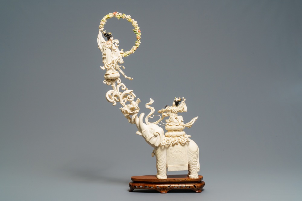 A large Chinese ivory group of an elephant with two ladies, 1st half 20th C.
