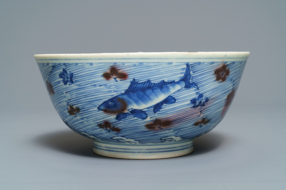 A Chinese blue and underglaze red bowl with carps and marine animals, Xuande mark, Kangxi