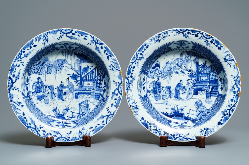 A pair of Chinese blue and white basins with figures in a garden, Yongzheng