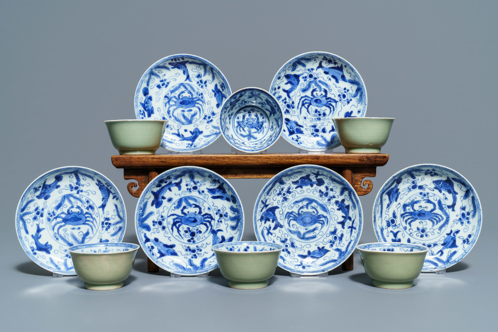 Six Chinese celadon and blue and white 'crabs and fish' cups and saucers, Kangxi