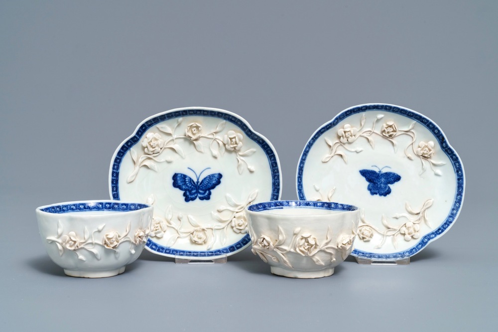 Een paar Chinese blauwwitte 'soft paste' koppen en schotels met reli&euml;fdecor, Qianlong