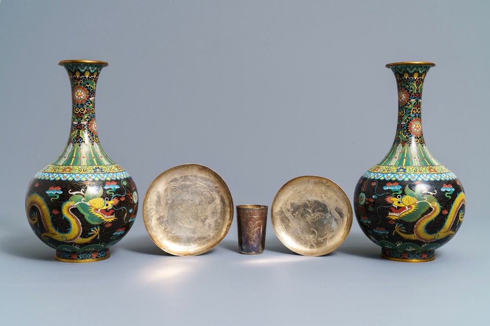 A pair of Chinese cloisonn&eacute; bottle vases, two silver saucers and a silver cup, 19/20th C.
