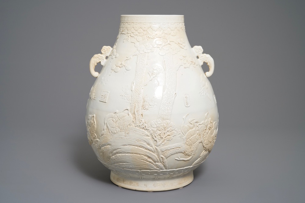A Chinese monochrome cream-glazed relief-decorated hu vase, Qianlong mark, 20th C.