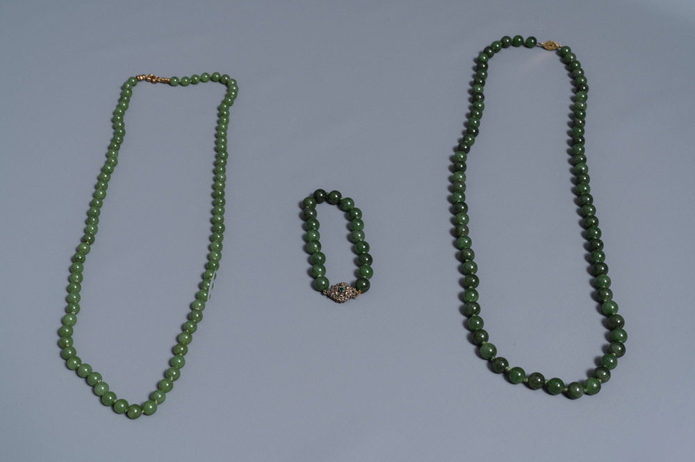Two Chinese necklaces and a bracelet with spinach green jade beads, 20th C.