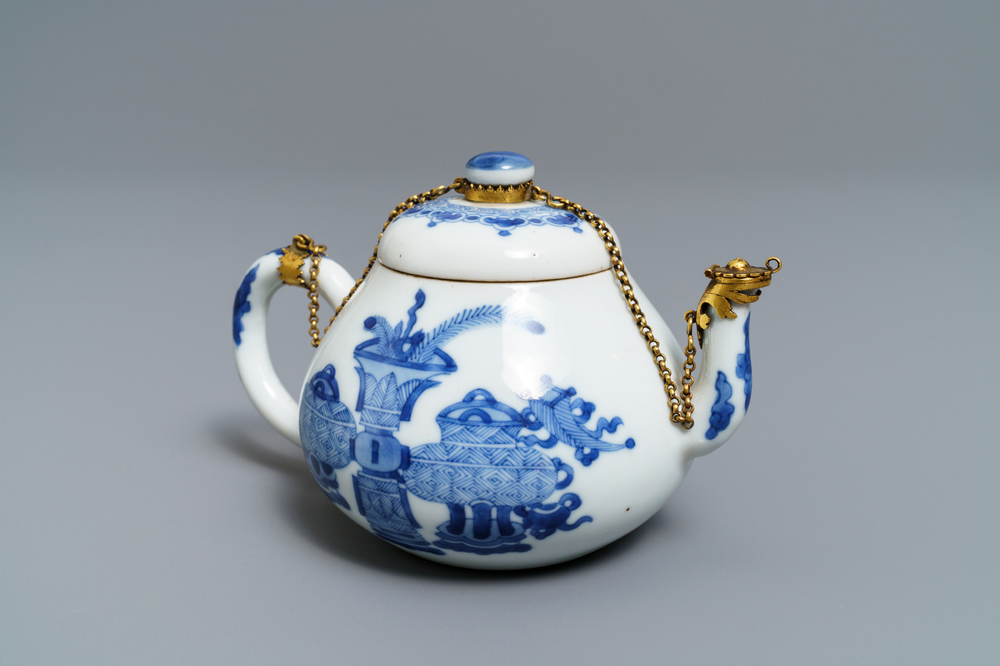 A Chinese blue and white gilt brass-mounted teapot, Jiajing mark, Kangxi
