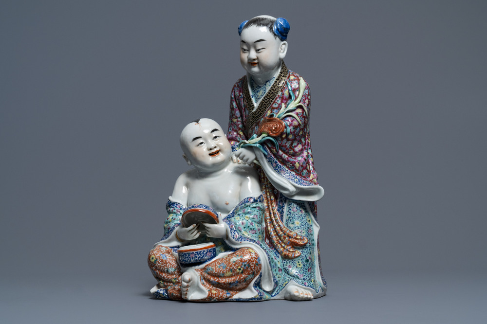 A Chinese famille rose group of two children, impressed marks, Republic, 20th C.