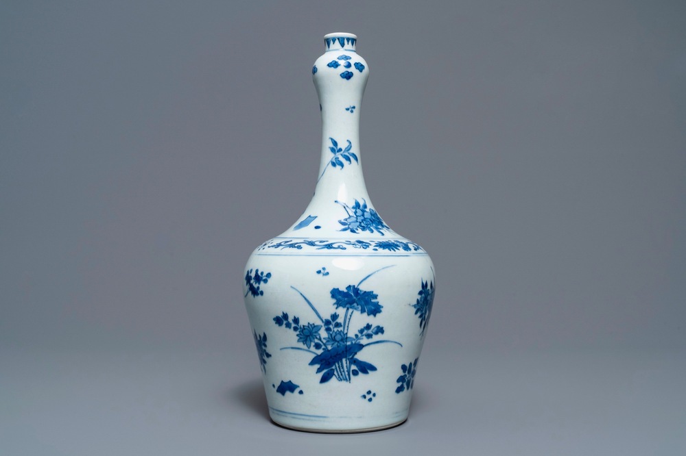 A Chinese blue and white bottle vase with floral design, Transitional period