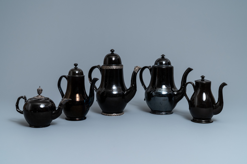 Four silver-mounted Namur black-glazed pottery coffeepots and a teapot, 18th C.