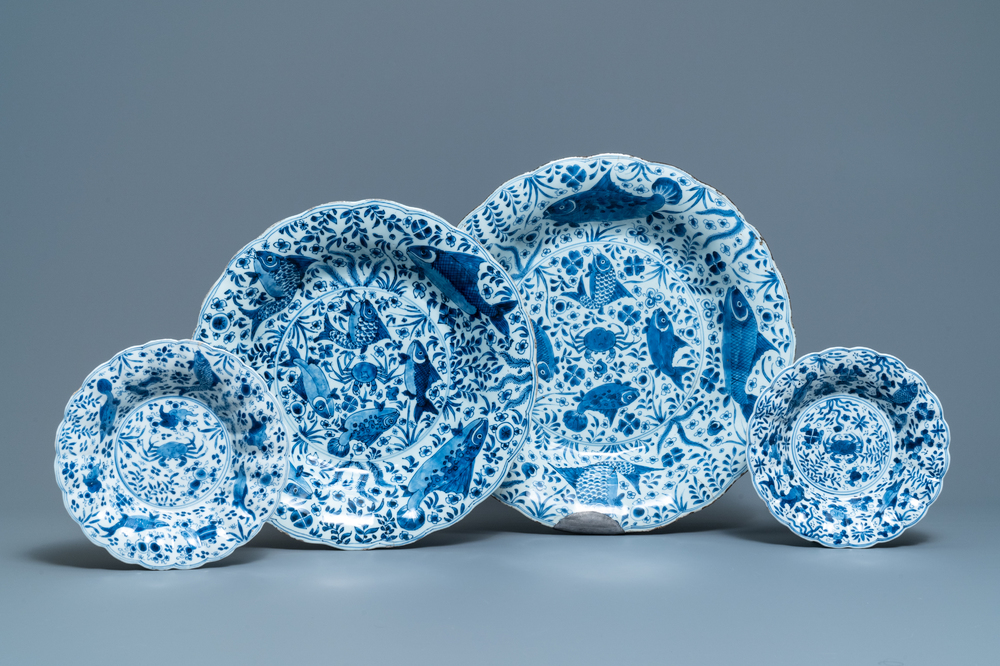 Two Chinese blue and white gadrooned 'crabs and carps' dishes and a pair of plates, Kangxi
