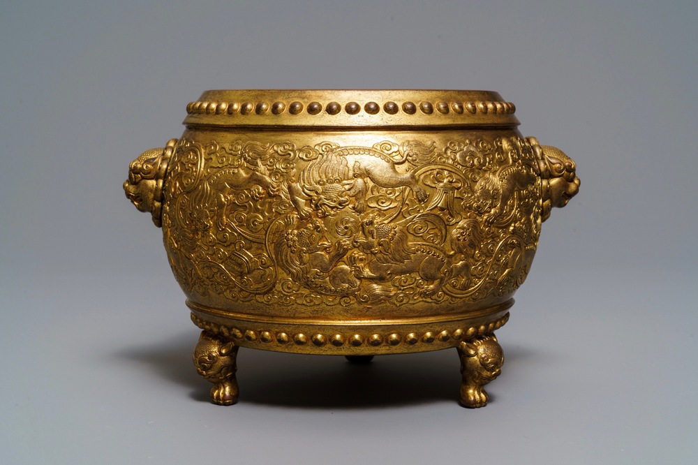 A Chinese gilt bronze tripod censer with buddhist lions, Qianlong mark, 19/20th C.