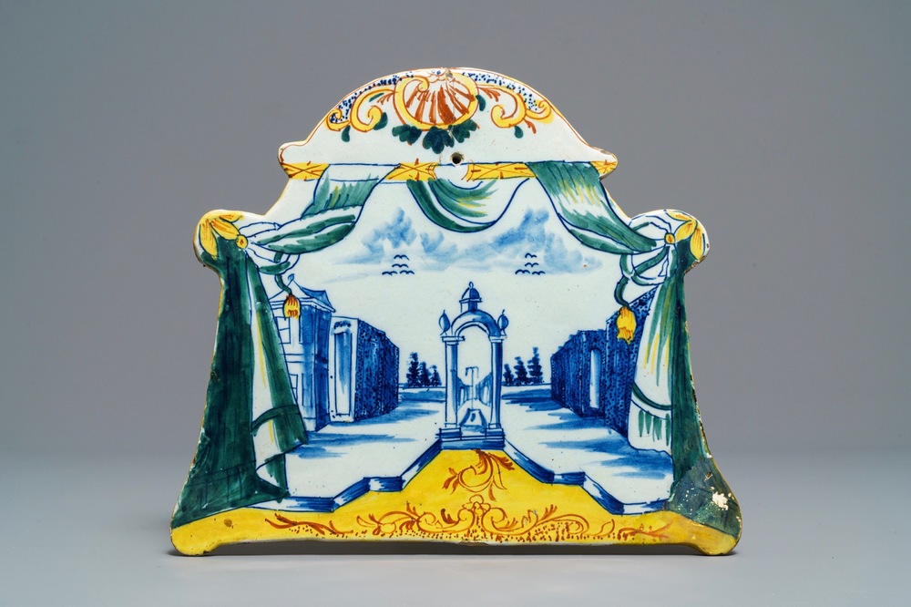 A polychrome Dutch Delft 'landscape' plaque with draperies, 18th C.