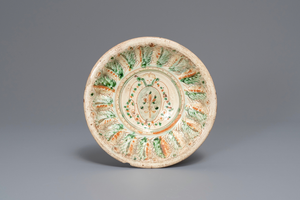 An Italian earthenware sgraffiato armorial dish, prob. Ferrara, 15/16th C.